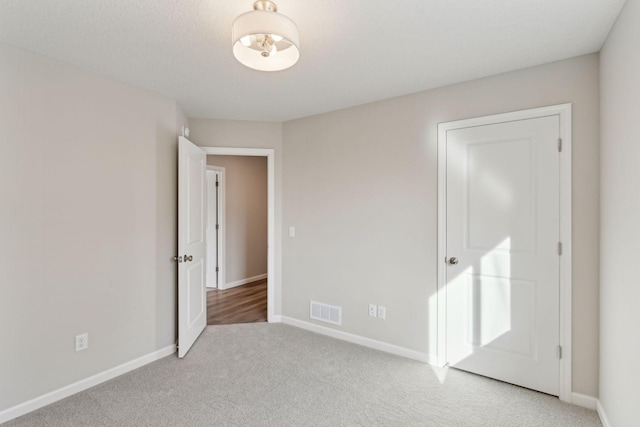 224 9th Ave Ct NW, Lonsdale, MN 55046 - unfurnished bedroom with visible vents, baseboards, and light colored carpet