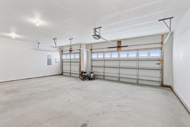 224 9th Ave Ct NW, Lonsdale, MN 55046 - garage with electric panel, a garage door opener, and baseboards