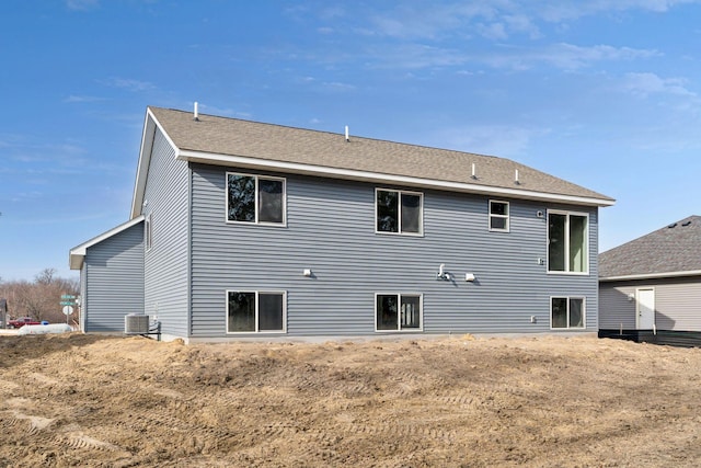 224 9th Ave Ct NW, Lonsdale, MN 55046 - rear view of property featuring central AC and roof with shingles
