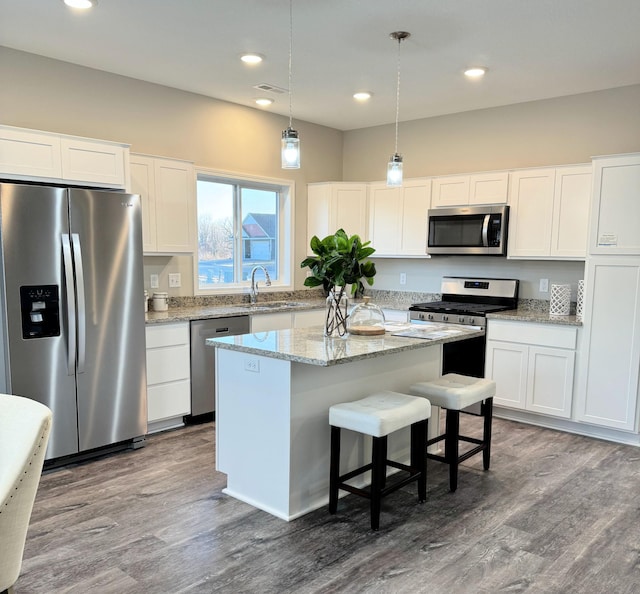 4905 Evergreen Dr N, Hugo, MN 55038 - kitchen with white cabinets, recessed lighting, a center island, appliances with stainless steel finishes, and decorative light fixtures