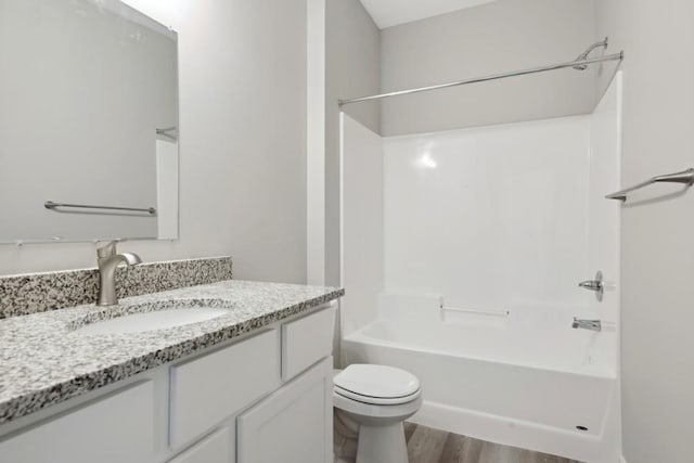 4905 Evergreen Dr N, Hugo, MN 55038 - full bathroom with toilet, wood finished floors, vanity, and washtub / shower combination