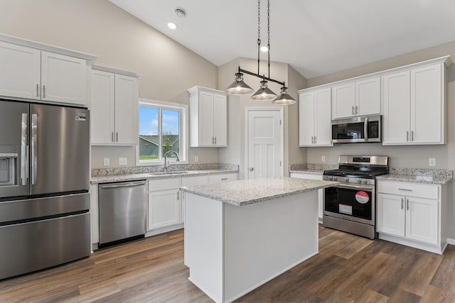 4905 Evergreen Dr N, Hugo, MN 55038 - kitchen featuring appliances with stainless steel finishes, white cabinetry, a kitchen island, dark wood finished floors, and recessed lighting