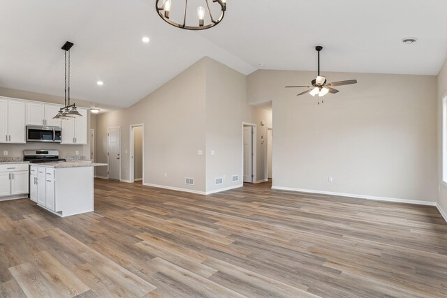 4905 Evergreen Dr N, Hugo, MN 55038 - kitchen with stainless steel appliances, open floor plan, a center island, white cabinets, and a ceiling fan