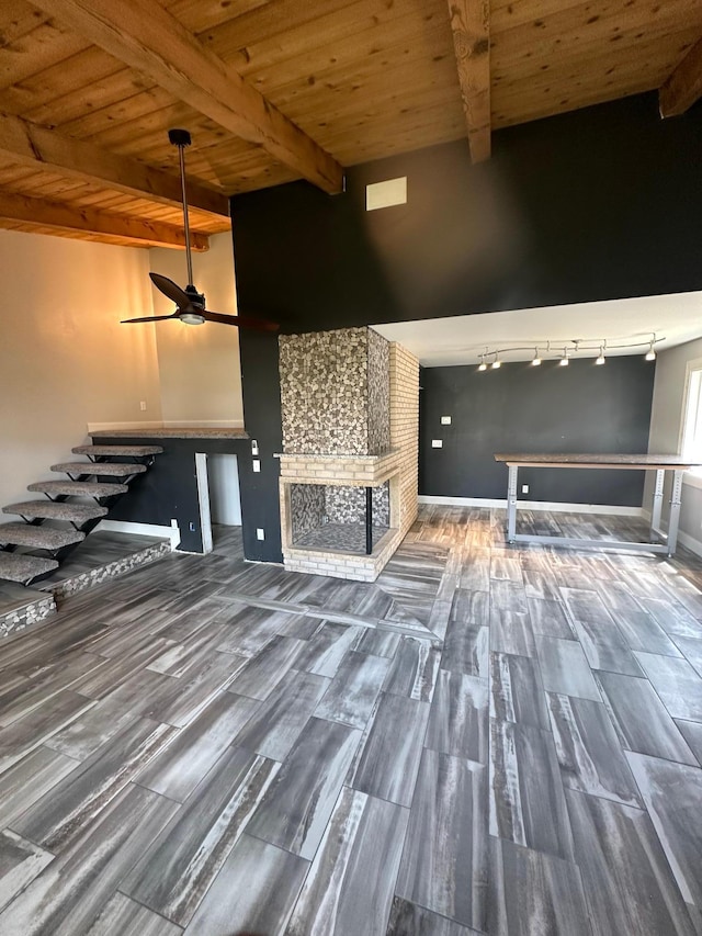 412 Holly Ln, Mankato, MN 56001 - unfurnished living room featuring beam ceiling, wooden ceiling, a fireplace, baseboards, and ceiling fan