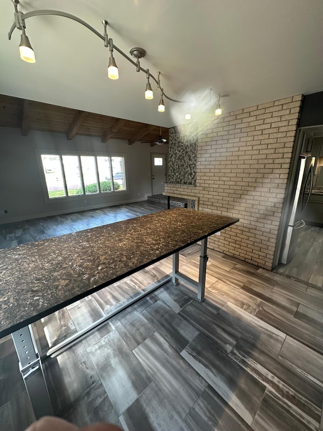 412 Holly Ln, Mankato, MN 56001 - playroom with beamed ceiling, wood finished floors, brick wall, and a ceiling fan