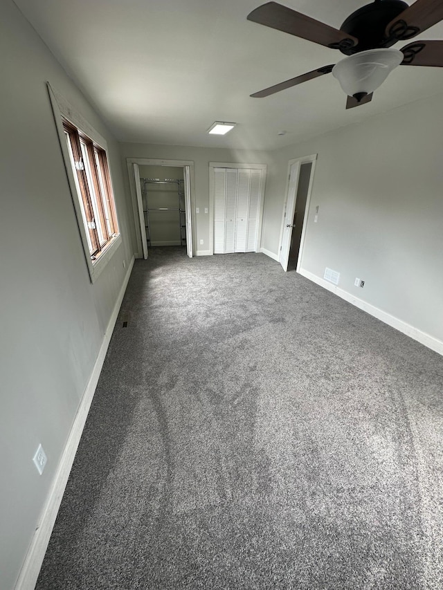412 Holly Ln, Mankato, MN 56001 - unfurnished bedroom with a ceiling fan, visible vents, carpet, and baseboards