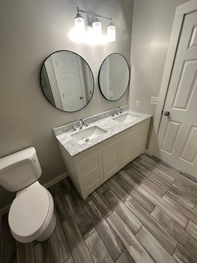 412 Holly Ln, Mankato, MN 56001 - bathroom featuring wood finish floors, toilet, and a sink