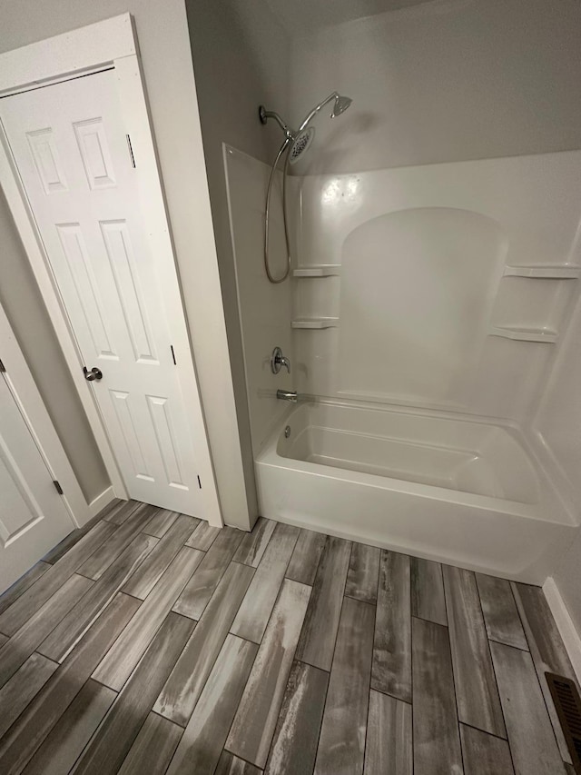 412 Holly Ln, Mankato, MN 56001 - bathroom with visible vents, shower / tub combination, and wood tiled floor