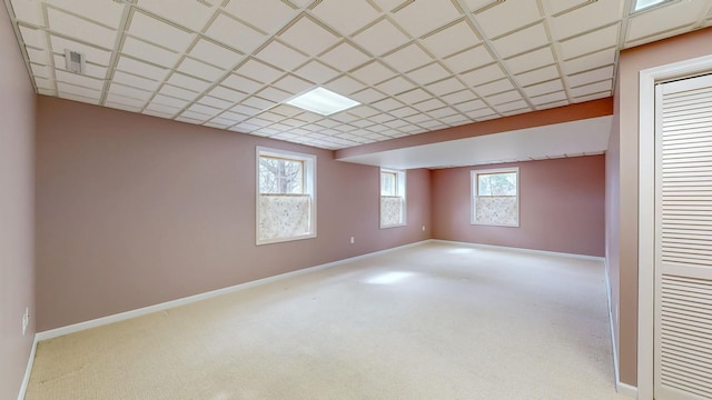 basement with a wealth of natural light, carpet flooring, and baseboards