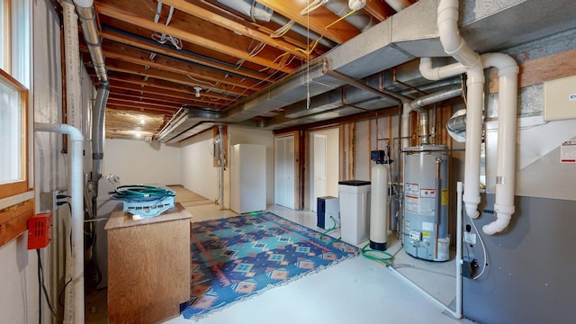 unfinished below grade area featuring water heater
