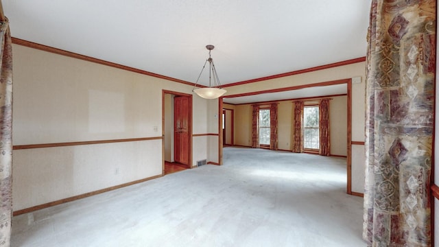 spare room featuring baseboards, ornamental molding, and carpet floors