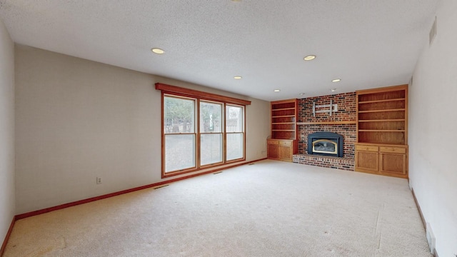 unfurnished living room featuring built in features, baseboards, carpet flooring, and a textured ceiling
