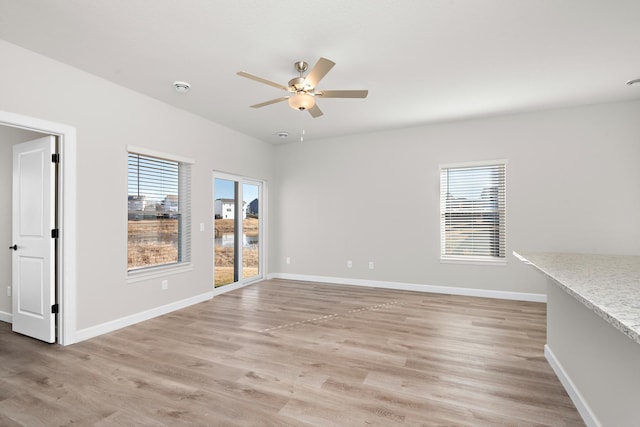 18756 Ivanhoe St NW, Elk River, MN 55330 - empty room with a ceiling fan, light wood finished floors, and a smoke detector