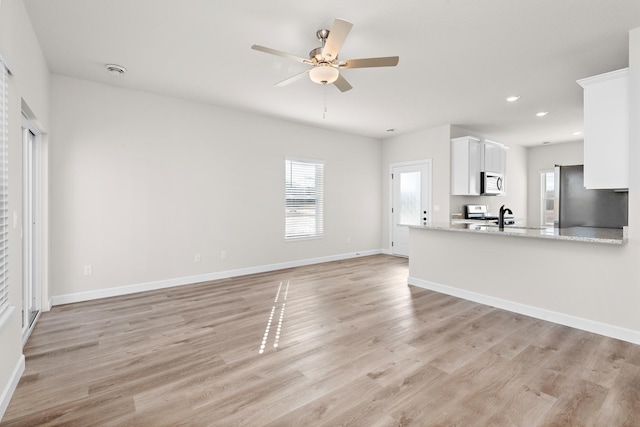 18756 Ivanhoe St NW, Elk River, MN 55330 - unfurnished living room with light wood finished floors, recessed lighting, and ceiling fan