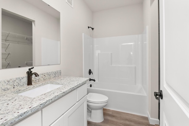 18756 Ivanhoe St NW, Elk River, MN 55330 - bathroom featuring vanity, wood finished floors, bathtub / shower combination, and a spacious closet