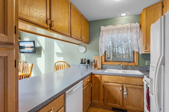 N2641 Cipra Rd, Sarona, WI 54870 - kitchen with white appliances, brown cabinets, and a textured ceiling