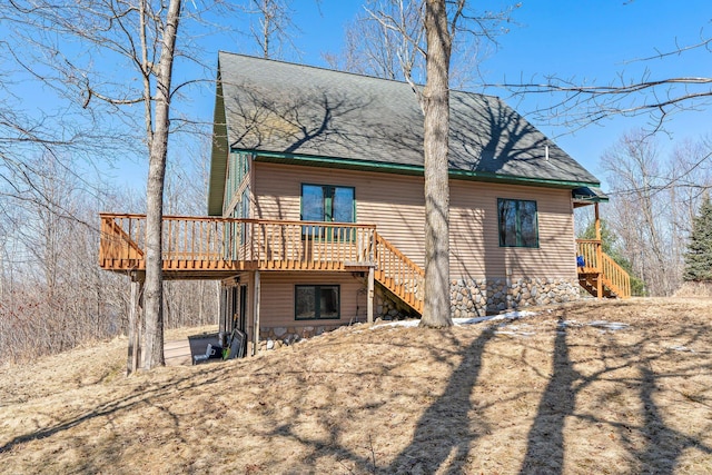 N2641 Cipra Rd, Sarona, WI 54870 - rear view of house with stairs, a wooden deck, and roof with shingles