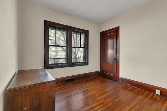 301 7th Ave S, Saint Cloud, MN 56301 - spare room with dark wood-style flooring and baseboards