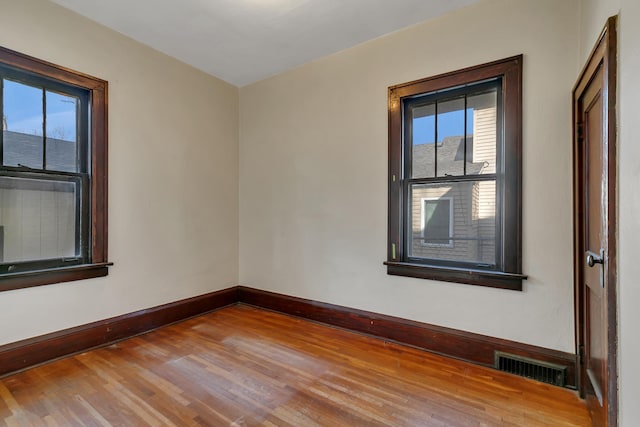 301 7th Ave S, Saint Cloud, MN 56301 - empty room featuring wood finished floors, plenty of natural light, and baseboards
