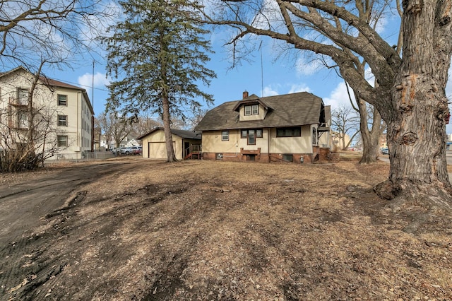 301 7th Ave S, Saint Cloud, MN 56301 - view of front of home with a chimney, dirt driveway, a garage, and roof with shingles