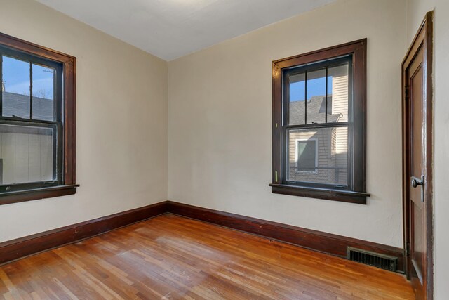 301 7th Ave S, Saint Cloud, MN 56301 - empty room with wood finished floors, healthy amount of natural light, and baseboards