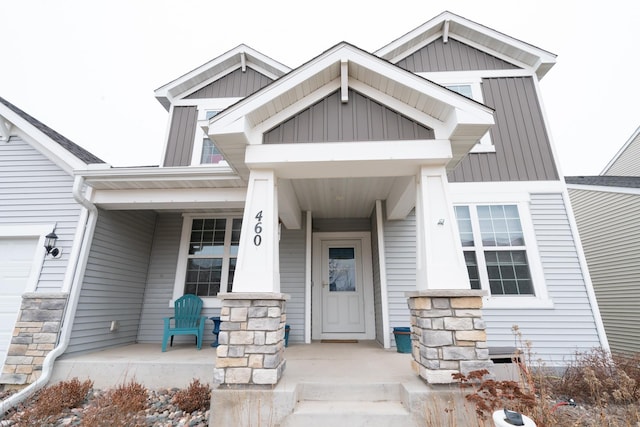 460 14th St NW, New Brighton, MN 55112 - view of exterior entry with covered porch and board and batten siding