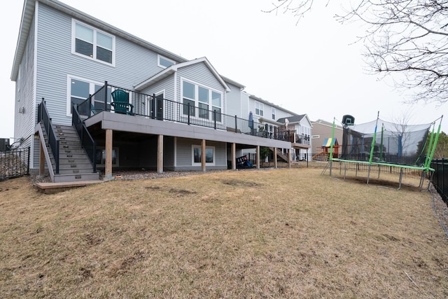 460 14th St NW, New Brighton, MN 55112 - back of property featuring stairs, a trampoline, and a deck