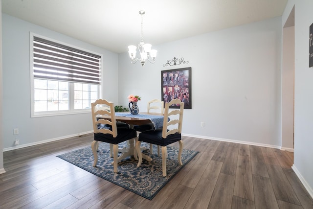 460 14th St NW, New Brighton, MN 55112 - dining space with a chandelier, dark wood-style flooring, and baseboards