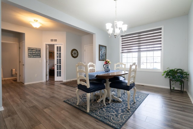 460 14th St NW, New Brighton, MN 55112 - dining area with wood finished floors, a chandelier, and baseboards