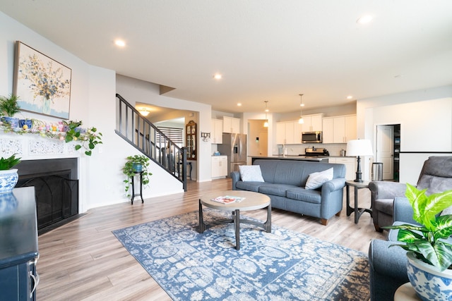 460 14th St NW, New Brighton, MN 55112 - living area with stairway, light wood-style flooring, recessed lighting, and a fireplace
