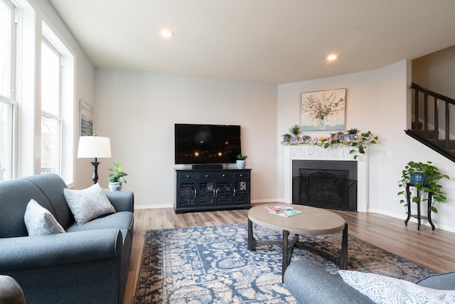 460 14th St NW, New Brighton, MN 55112 - living room featuring wood finished floors, a fireplace, recessed lighting, baseboards, and stairs