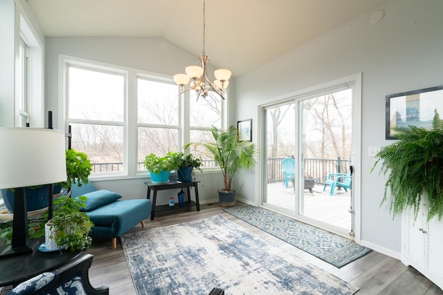 460 14th St NW, New Brighton, MN 55112 - sitting room with a chandelier, wood finished floors, vaulted ceiling, and baseboards