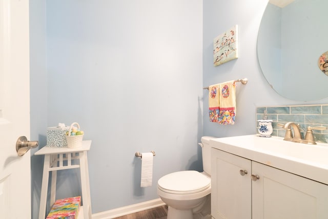 460 14th St NW, New Brighton, MN 55112 - half bath with toilet, decorative backsplash, wood finished floors, and vanity