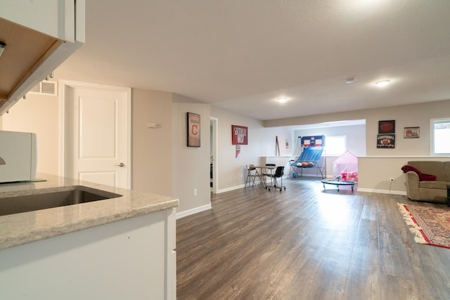 460 14th St NW, New Brighton, MN 55112 - kitchen with dark wood-style floors, open floor plan, baseboards, and light stone counters