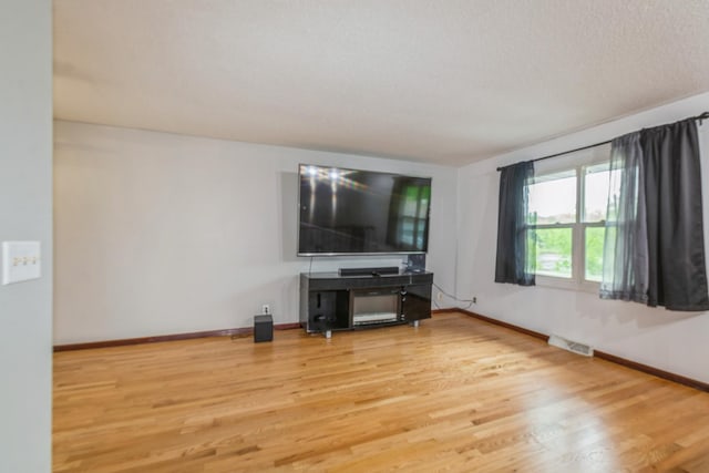 living area with wood finished floors and baseboards