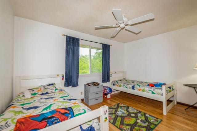 bedroom with wood finished floors and ceiling fan