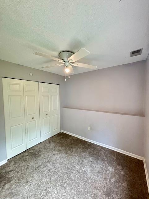 unfurnished bedroom featuring carpet floors, a closet, baseboards, and a textured ceiling