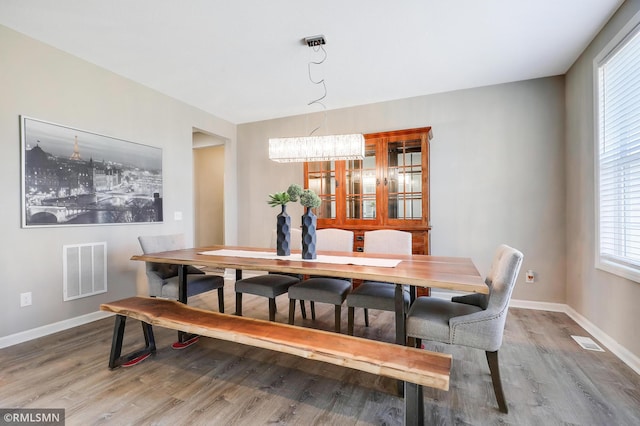 7122 156th St, Savage, MN 55378 - dining area with wood finished floors, baseboards, and a chandelier
