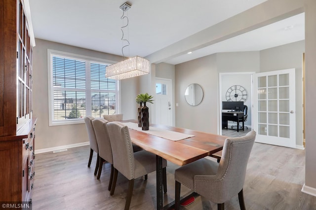 7122 156th St, Savage, MN 55378 - dining room featuring wood finished floors, baseboards, and a chandelier