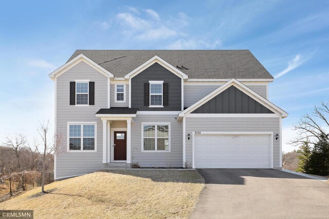 7122 156th St, Savage, MN 55378 - view of front facade with asphalt driveway, roof with shingles, board and batten siding, and an attached garage