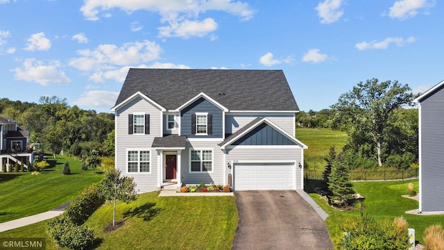 7122 156th St, Savage, MN 55378 - view of front facade featuring driveway, board and batten siding, an attached garage, and a shingled roof