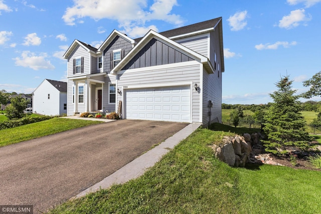 7122 156th St, Savage, MN 55378 - view of front of home with driveway, a front lawn, an attached garage, and board and batten siding