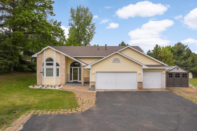 2222 Crosstown Blvd NE, Ham Lake, MN 55304 - view of front of property with driveway, brick siding, a garage, and a front yard