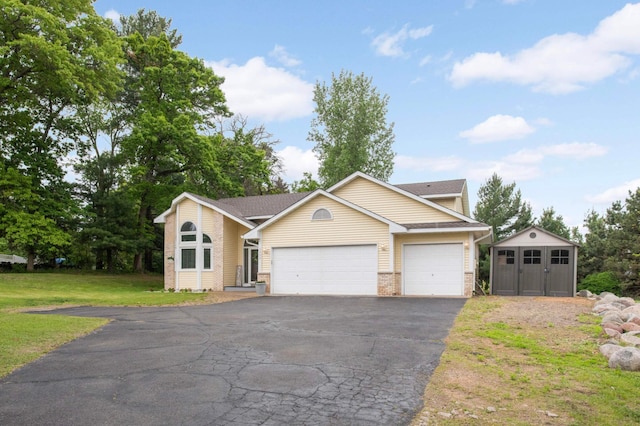 2222 Crosstown Blvd NE, Ham Lake, MN 55304 - view of front of house with an attached garage, brick siding, a front yard, and asphalt driveway