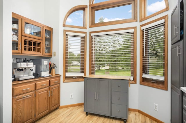 2222 Crosstown Blvd NE, Ham Lake, MN 55304 - kitchen with light wood-style flooring, glass insert cabinets, light countertops, baseboards, and gray cabinets