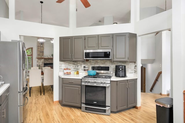 2222 Crosstown Blvd NE, Ham Lake, MN 55304 - kitchen with stainless steel appliances, gray cabinets, a ceiling fan, tasteful backsplash, and high vaulted ceiling