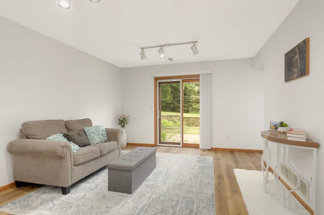2222 Crosstown Blvd NE, Ham Lake, MN 55304 - living area featuring track lighting, light wood-style flooring, and baseboards