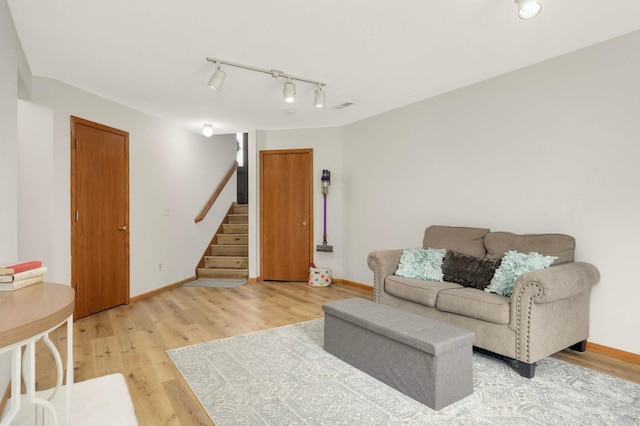 2222 Crosstown Blvd NE, Ham Lake, MN 55304 - living area with stairs, light wood-style flooring, rail lighting, and baseboards