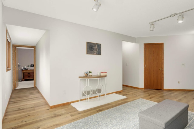 2222 Crosstown Blvd NE, Ham Lake, MN 55304 - living area featuring rail lighting, wood finished floors, and baseboards
