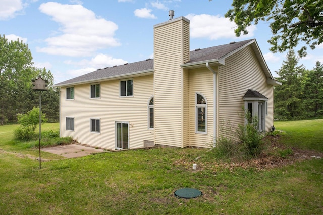 2222 Crosstown Blvd NE, Ham Lake, MN 55304 - back of property featuring a chimney, a yard, a patio area, and a shingled roof